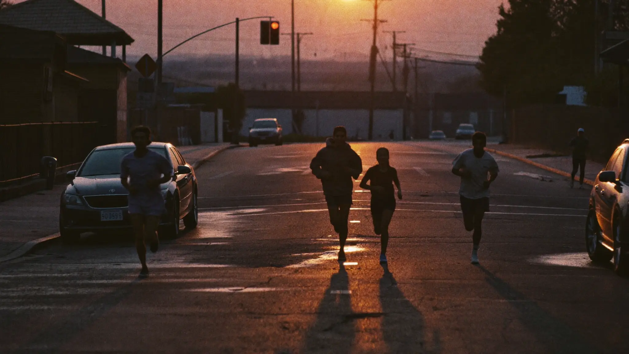 A crew running through empty streets at dawn